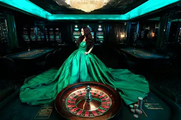 A woman smiling by bright slot machines showing lucky symbols, showcasing the exciting slot offerings at FFBETT.