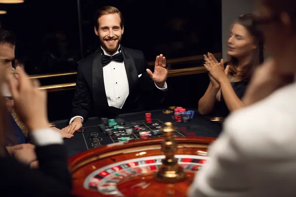 A confident dealer surrounded by casino chips inviting players to access their FFBETT account, reflecting quick and easy login options.